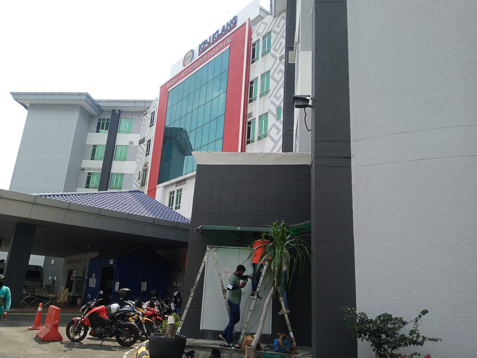Exterior view of a commercial building during awning installation.