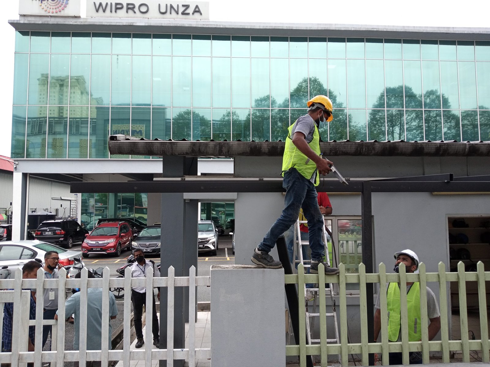 Worker installing the steel frame for an ACP guardhouse awning at Wipro in Subang Jaya, Selangor.